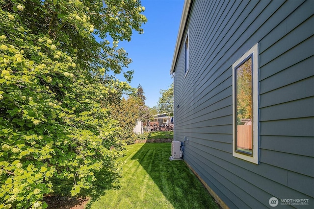view of side of home featuring a lawn