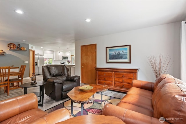 living area with recessed lighting and light wood-type flooring
