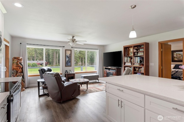 living area featuring a ceiling fan, recessed lighting, and light wood-type flooring
