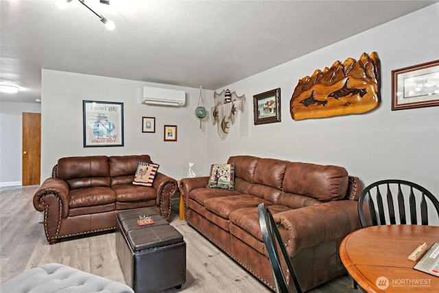 living room featuring an AC wall unit and light wood-style floors