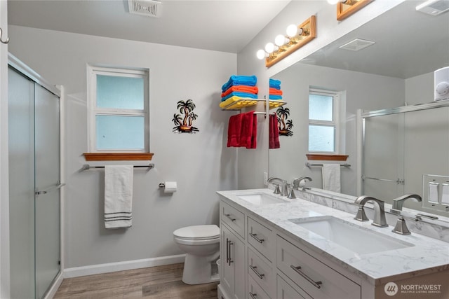 full bathroom with visible vents, a sink, and a stall shower