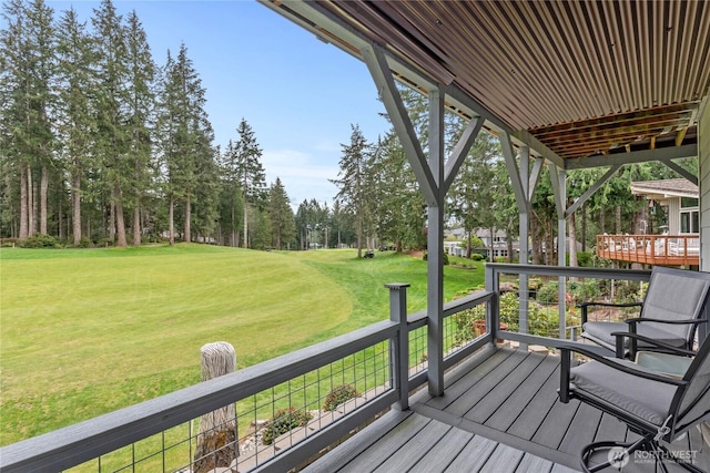 wooden terrace featuring a yard