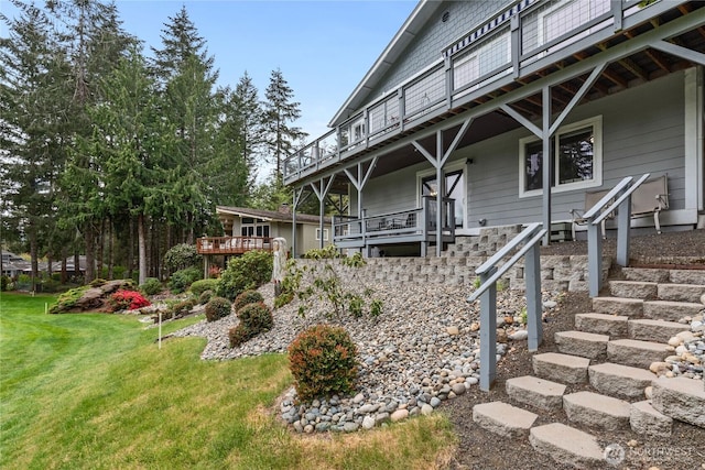 exterior space featuring stairs and a yard