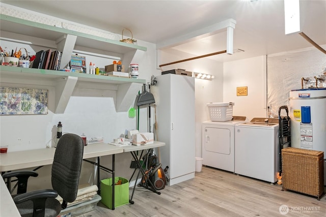 laundry area with separate washer and dryer, laundry area, water heater, and wood finished floors