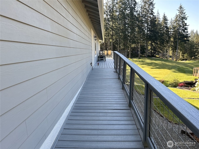 wooden terrace featuring a yard