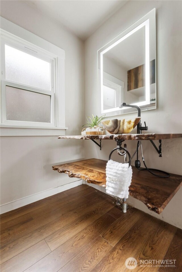 dining area featuring baseboards and wood finished floors