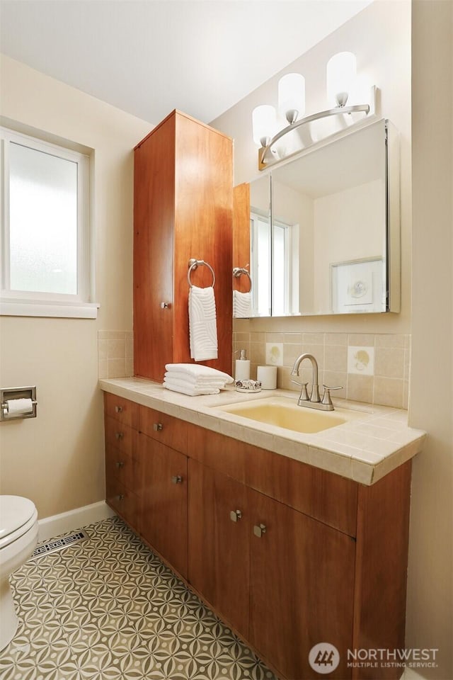 15506 Juanita Dr NE, Kenmore, WA 98028 - bathroom with toilet, baseboards, a healthy amount of sunlight, and vanity