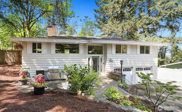15506 Juanita Dr NE, Kenmore, WA 98028 - back of property with an attached garage, fence, and a chimney