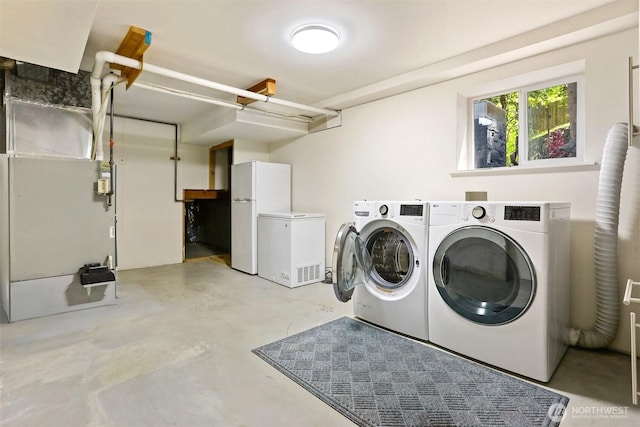 15506 Juanita Dr NE, Kenmore, WA 98028 - washroom featuring separate washer and dryer and heating unit