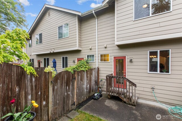 rear view of house with fence