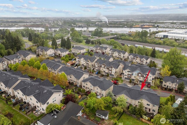 birds eye view of property with a water view and a residential view