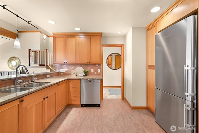 kitchen with recessed lighting, a sink, decorative backsplash, and appliances with stainless steel finishes