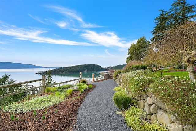 surrounding community featuring a water view
