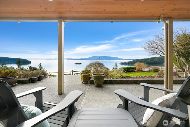 view of patio featuring a water and mountain view