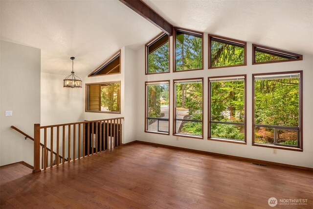 interior space featuring baseboards, a notable chandelier, and a healthy amount of sunlight