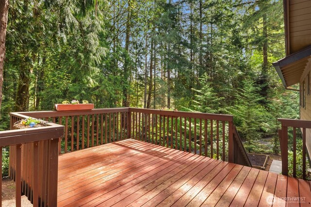 wooden terrace with a forest view