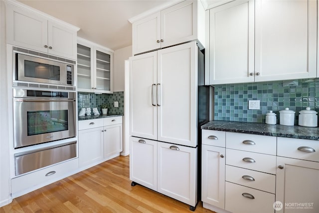 8012 Chinook Way, Blaine, WA 98230 - kitchen featuring white cabinets, light wood-style floors, built in appliances, decorative backsplash, and a warming drawer