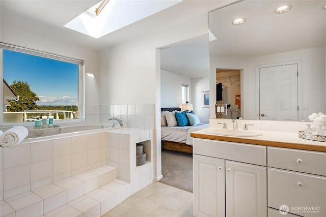 8012 Chinook Way, Blaine, WA 98230 - bathroom featuring vanity, tile patterned floors, recessed lighting, a skylight, and a bath