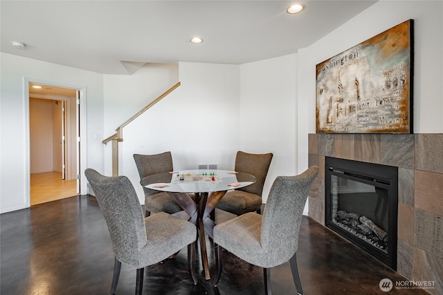 8012 Chinook Way, Blaine, WA 98230 - dining area featuring recessed lighting, finished concrete flooring, a tiled fireplace, and visible vents