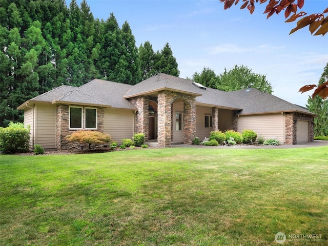 view of front facade with an attached garage, a front lawn, and stone siding