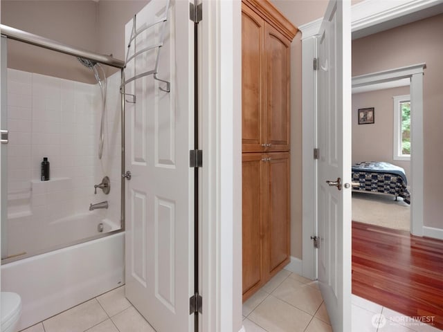 full bath with toilet, shower / washtub combination, and tile patterned flooring