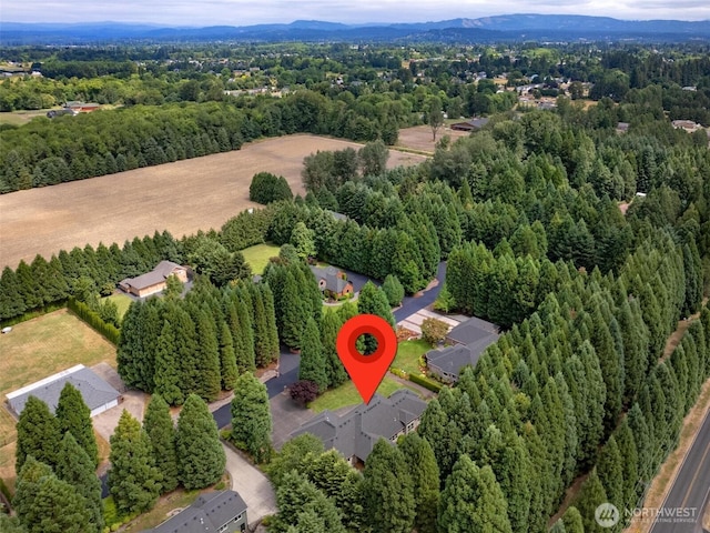 birds eye view of property featuring a wooded view