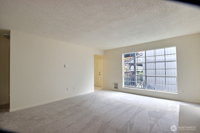 3425 S 176th St Unit 227, Seatac, WA 98188 - carpeted spare room featuring a textured ceiling and baseboards