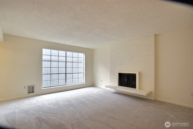3425 S 176th St Unit 227, Seatac, WA 98188 - unfurnished living room featuring a textured ceiling, visible vents, a brick fireplace, baseboards, and carpet flooring