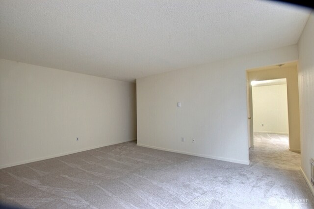 3425 S 176th St Unit 227, Seatac, WA 98188 - spare room with a textured ceiling, baseboards, and carpet floors