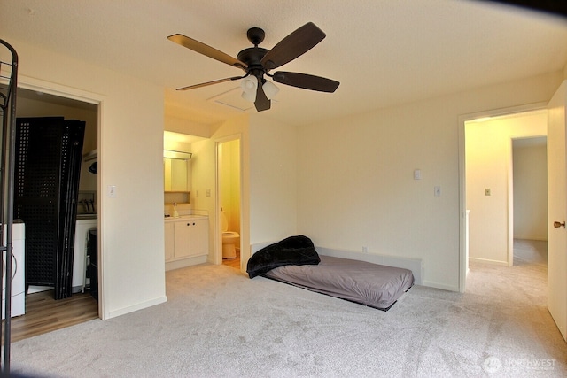 3425 S 176th St Unit 227, Seatac, WA 98188 - bedroom with baseboards, connected bathroom, carpet, and ceiling fan