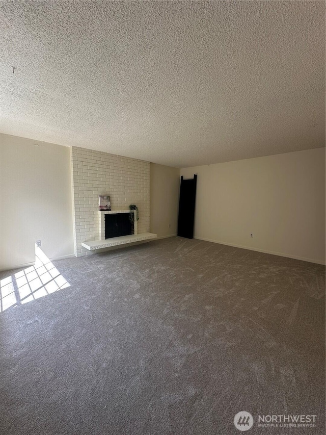3425 S 176th St Unit 227, Seatac, WA 98188 - unfurnished living room with a textured ceiling, a brick fireplace, and carpet floors