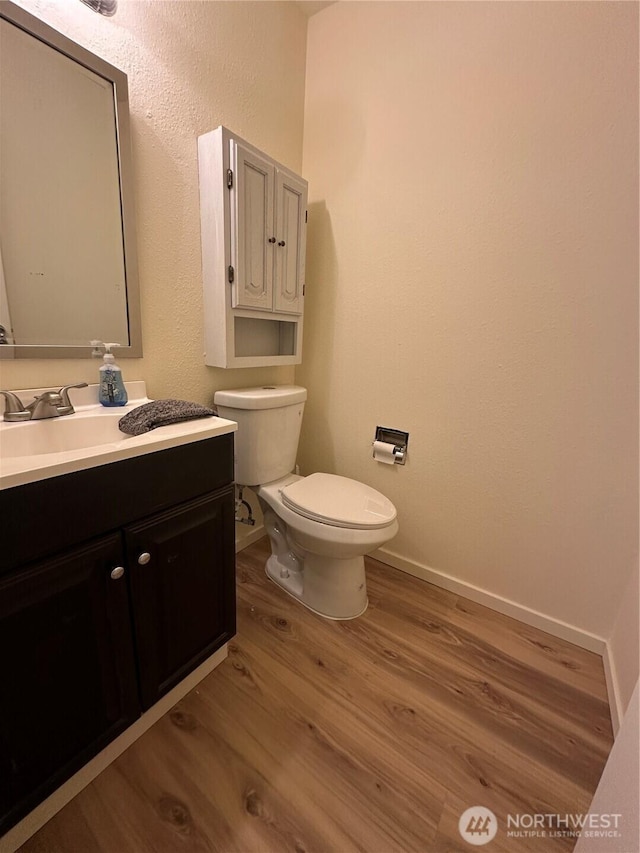 3425 S 176th St Unit 227, Seatac, WA 98188 - bathroom with toilet, baseboards, wood finished floors, and vanity