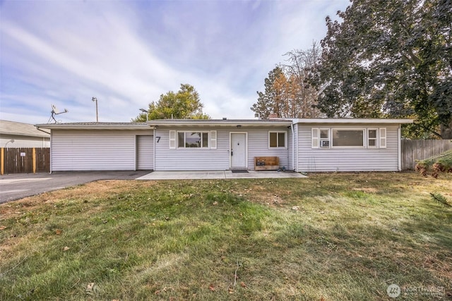ranch-style home featuring fence, a patio area, and a front yard