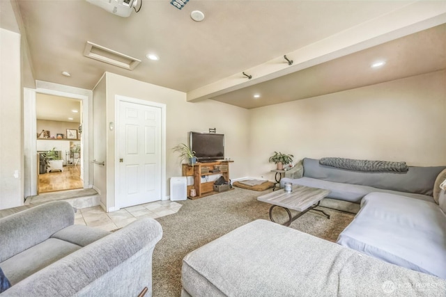 living area with recessed lighting, attic access, light tile patterned floors, and light colored carpet