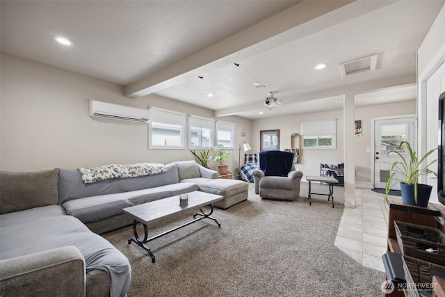 living room featuring an AC wall unit, recessed lighting, a wealth of natural light, and attic access