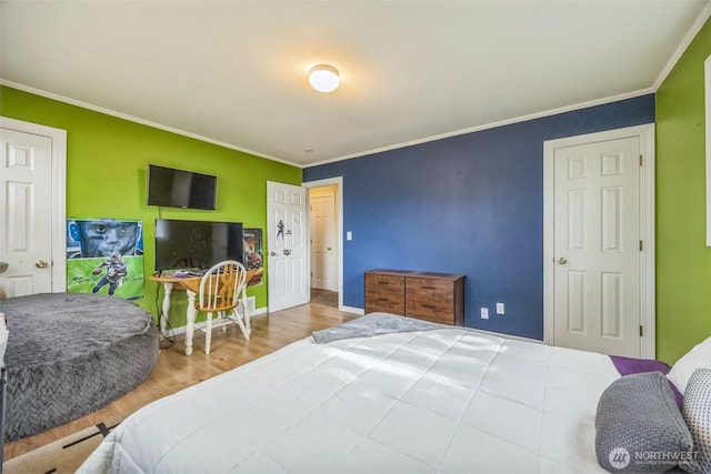 bedroom featuring crown molding, baseboards, and wood finished floors