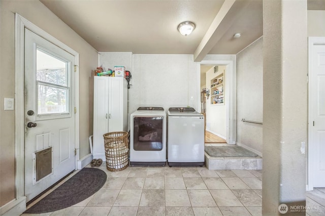 laundry area featuring laundry area, independent washer and dryer, light tile patterned floors, and visible vents