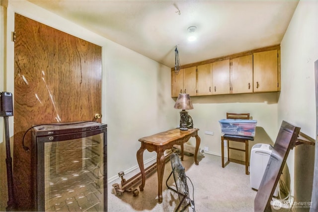 home office featuring light colored carpet and baseboards