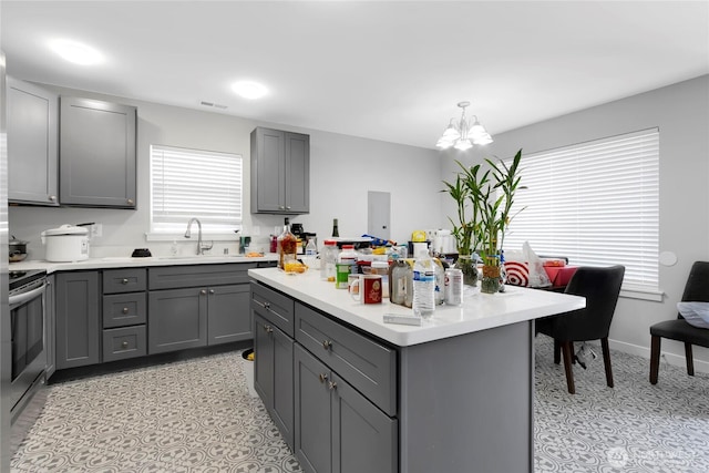 kitchen with a sink, gray cabinets, and visible vents