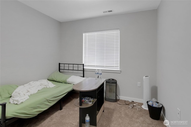 carpeted bedroom with visible vents and baseboards
