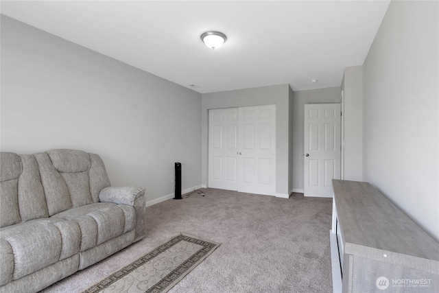 living area with carpet flooring and baseboards