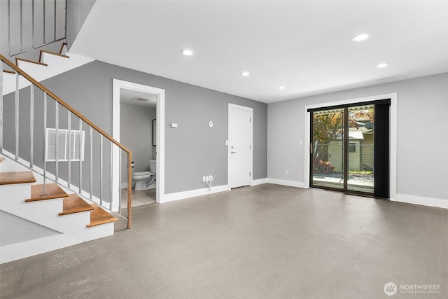 23255 133rd Ave SE, Kent, WA 98042 - unfurnished living room with recessed lighting, baseboards, concrete flooring, and stairway