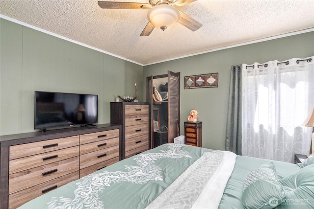 bedroom with a closet, ornamental molding, a ceiling fan, and a textured ceiling