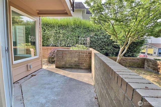 view of patio featuring fence