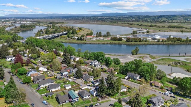 birds eye view of property with a water and mountain view