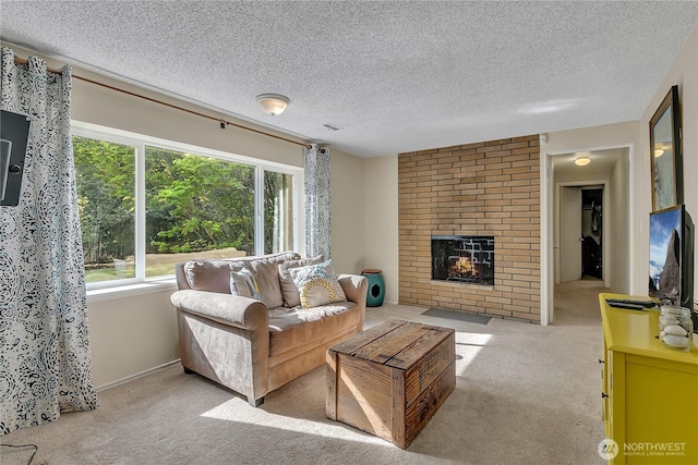 carpeted living room with a brick fireplace and a textured ceiling