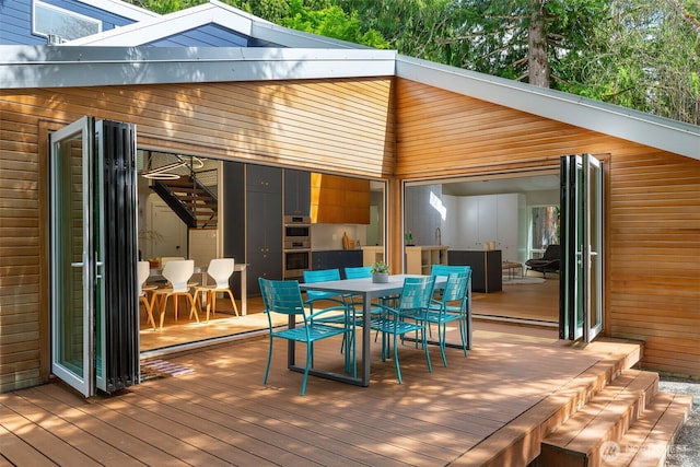 wooden terrace with outdoor dining area