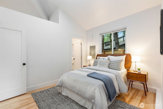 bedroom featuring light wood-style floors, baseboards, and high vaulted ceiling