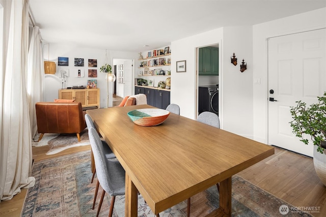 dining room featuring light wood-style floors and washer / clothes dryer