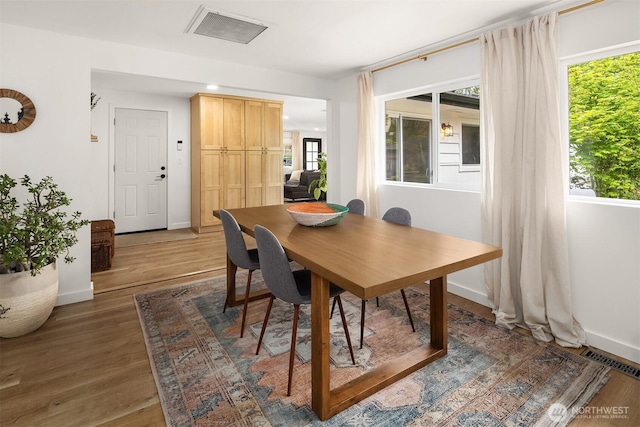 dining room with recessed lighting, baseboards, visible vents, and wood finished floors